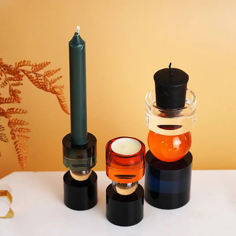 A striking display of Yosef Candle Holders in three different sizes, showcasing their modern geometric design and multicolor finish. The candle holders are crafted from premium crystal, providing a luxurious and sophisticated look. Their vibrant colors and sleek shapes add a contemporary touch to any home decor. Ideal for home décor enthusiasts, these versatile pieces can be mixed and matched to create stunning arrangements that elevate any space.