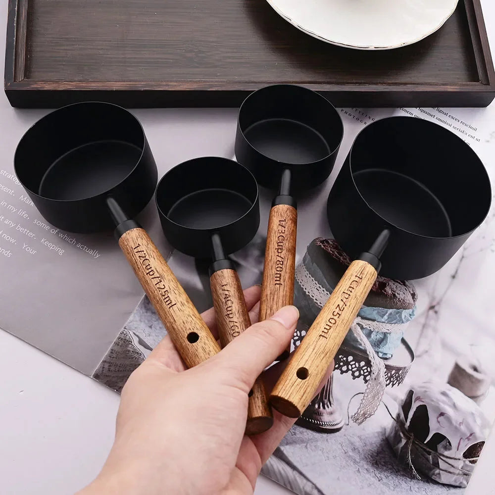 Stylish Lydia Measuring Cup & Spoon Set with wooden handles and stainless steel in black or gold, 8-piece set with engraved sizes for precise measurements, perfect for home décor enthusiasts and functional kitchen style.