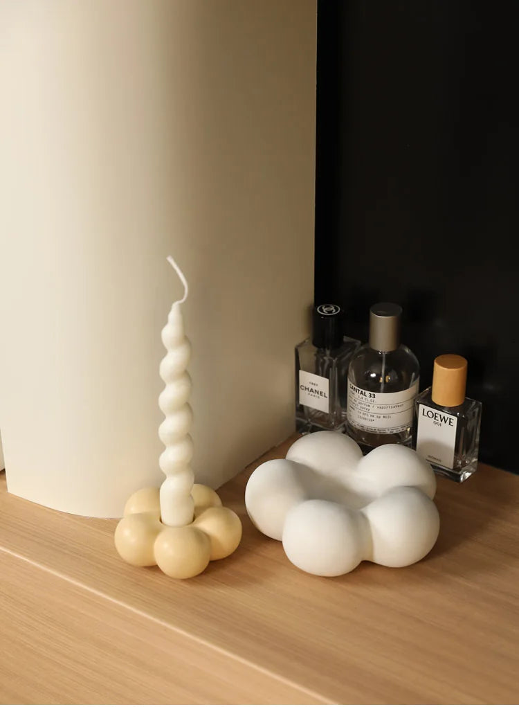 Modern ceramic Uchi candle holder in flower shape, available in various colorways, perfect for small or large candles.