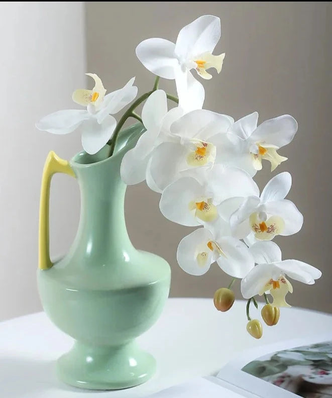 Colorful ceramic vase for floral display, bright décor accent.
