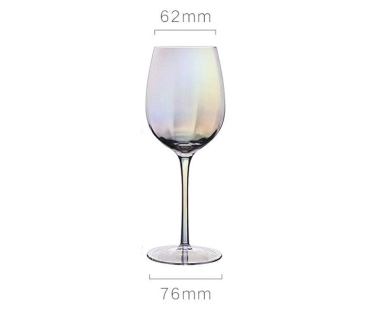 A collection of iridescent glassware from Domus Forge, featuring wine glasses, champagne coupes, decanters, and highball glasses in pastel gradient hues.