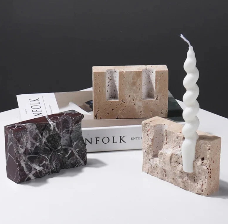 Brutalist candle holder with marble or travertine, anti-slip padding for stability.