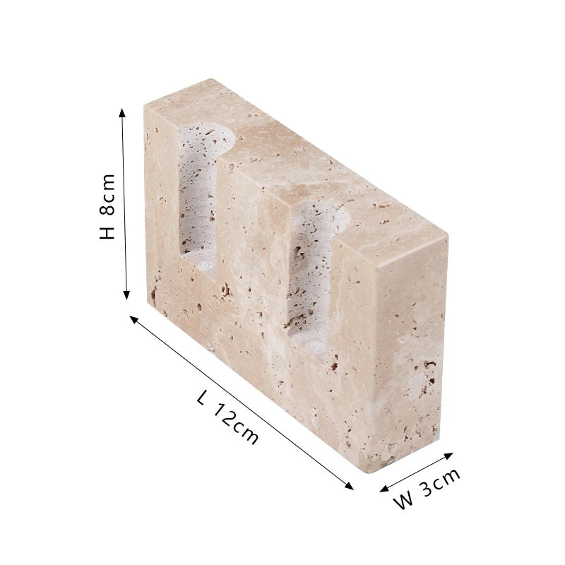 Brutalist candle holder with marble or travertine, anti-slip padding for stability.