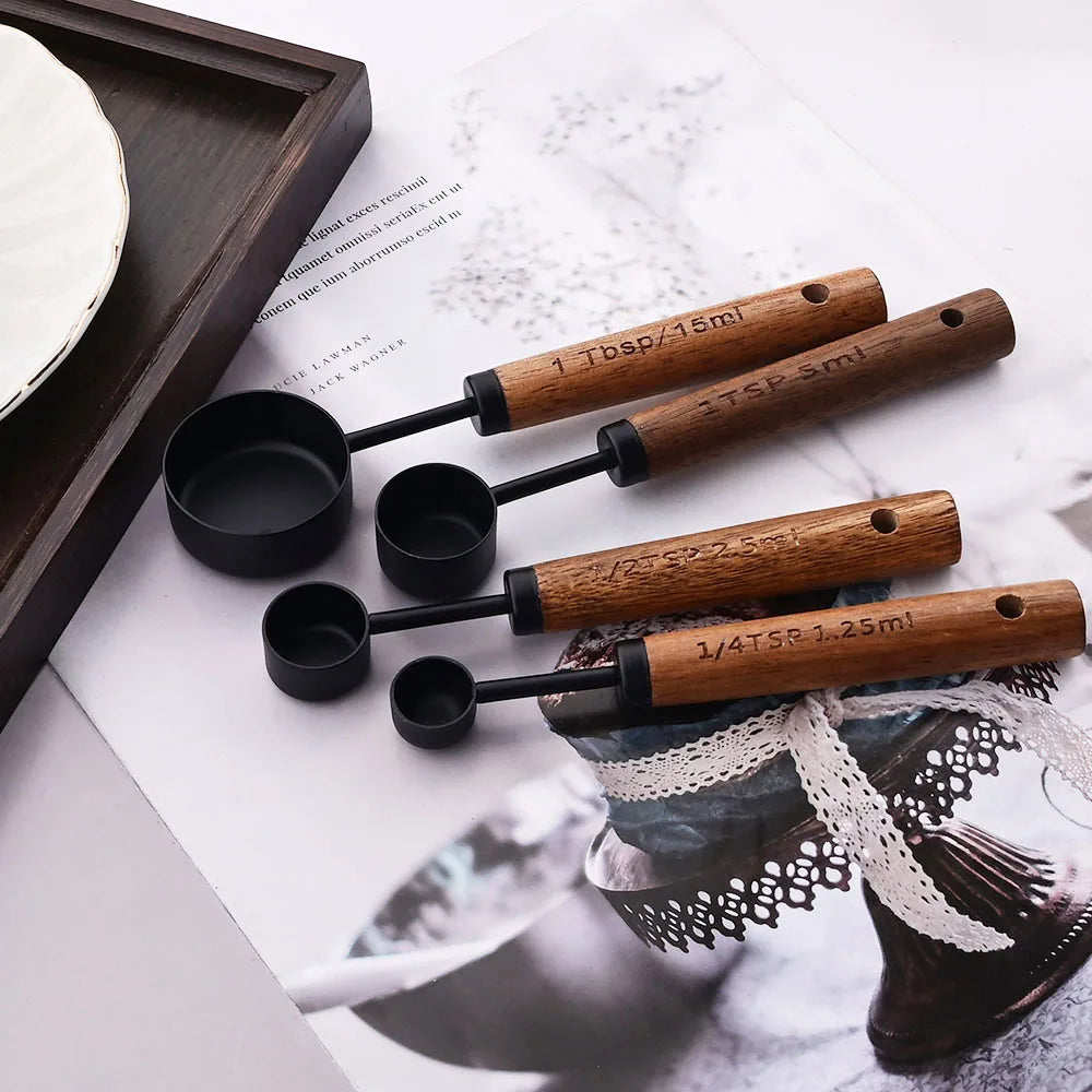 Stylish Lydia Measuring Cup & Spoon Set with wooden handles and stainless steel in black or gold, 8-piece set with engraved sizes for precise measurements, perfect for home décor enthusiasts and functional kitchen style.