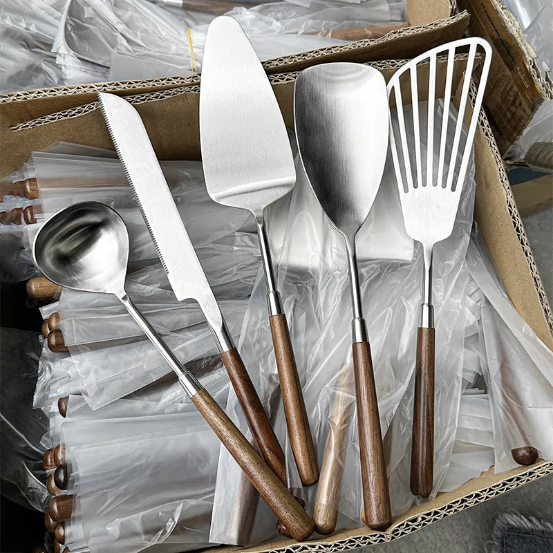 Wanda Serving Set – modern stainless steel serveware with elegant walnut handles, including a cake knife, cake shovel, serving spoon, ladle, and slotted turner for effortless entertaining.