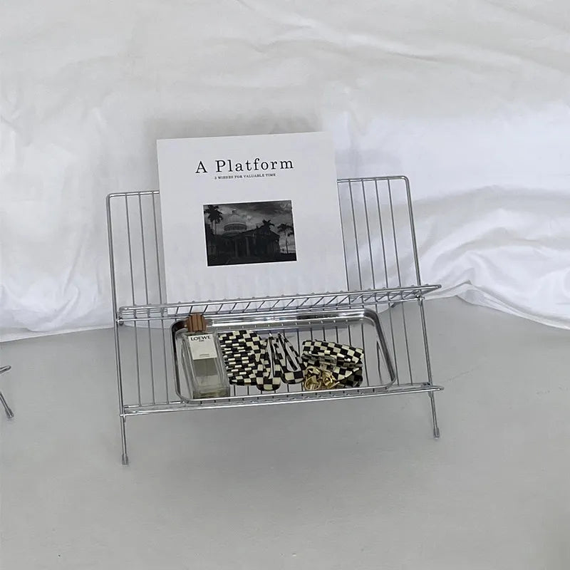 Image of the Elli Rack, a versatile Stainless Steel Magazine and Kitchen Rack in a sleek silver finish. Modern, simple design suitable for various uses in the kitchen or living spaces, adding contemporary elegance to your home.