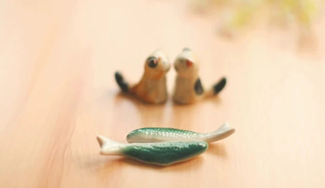 Zakka Chopstick Holder - Hand-painted porcelain fish in green and white ceramic. Perfect for hosting, intricate details, available as a single or pair. Small yet impactful dining accessory.