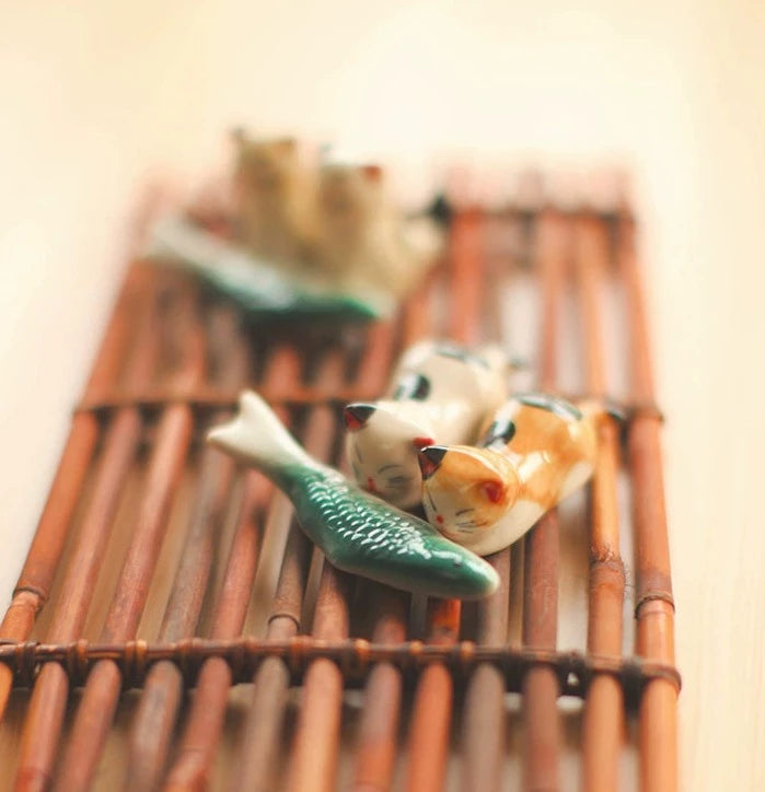 Zakka Chopstick Holder - Hand-painted porcelain fish in green and white ceramic. Perfect for hosting, intricate details, available as a single or pair. Small yet impactful dining accessory.