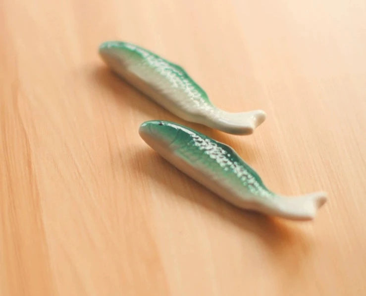 Zakka Chopstick Holder - Hand-painted porcelain fish in green and white ceramic. Perfect for hosting, intricate details, available as a single or pair. Small yet impactful dining accessory.