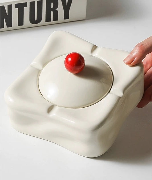 Foresta Ceramic Ashtray with cute ball detail, irregular shape, and modern design. Available in various colorways, choose between lidded or lidless options to suit your style. Crafted from high-quality ceramic for a sleek and contemporary smoking accessory.