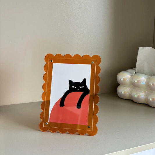 abio Frame featuring a scalloped design in vibrant colors, made from durable acrylic. Available in four sizes, this rectangular frame can be displayed vertically or horizontally. Perfect for home decor enthusiasts looking to add a playful and stylish touch to their space, ideal for framing art or photographs.