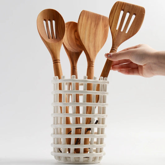 Joni Utensil Holder in ceramic with a basket weave look, available in white or cream and three sizes: small, medium, large. Hand-kneaded design, perfect for kitchen enthusiasts to keep utensils handy and countertops tidy.