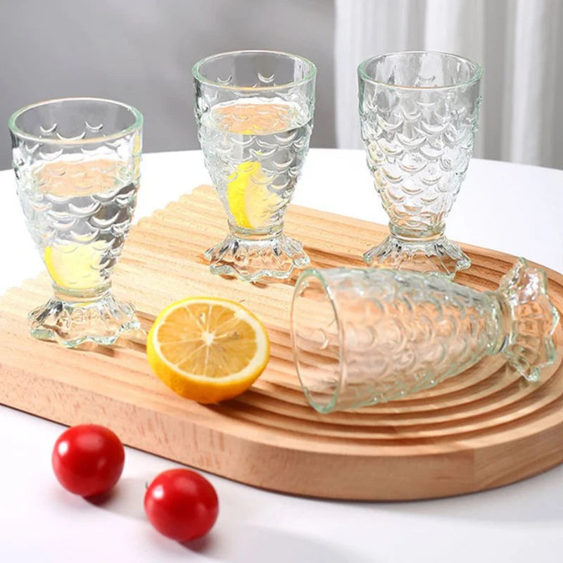 Domani Fish Glass Set – set of four 6-ounce clear glasses with a unique fish scale texture, perfect for serving cocktails, juice, or stylish drinks with whimsical elegance.
