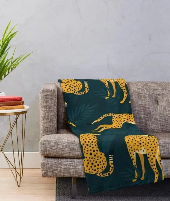 Yadhu Throw Blanket featuring a bold cheetah print in dark, moody tones. Available in four sizes—small, standard, large, and lap blanket. Made from soft, cozy flannel, this rectangular throw is perfect for adding a stylish touch to any room. Ideal for home décor enthusiasts, used for both comfort and decorative layering on furniture.