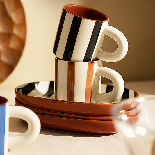 Harlan Mug & Saucer set featuring a chic striped design in black or blue. This stylish set includes a 6-ounce mug paired with a matching saucer, ideal for coffee or tea. Perfect for home décor enthusiasts looking to add a modern touch to their serveware collection.