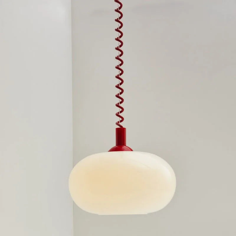 Modern Toz Pendant Light with hand-blown milkglass shade, colored coiled cord in primary colors, and adjustable length.